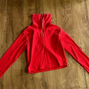 Long sleeve crop top. Can be worn with zipper down.